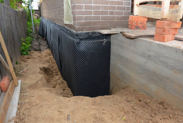Happy homeowners after waterproofing job in Fall Branch